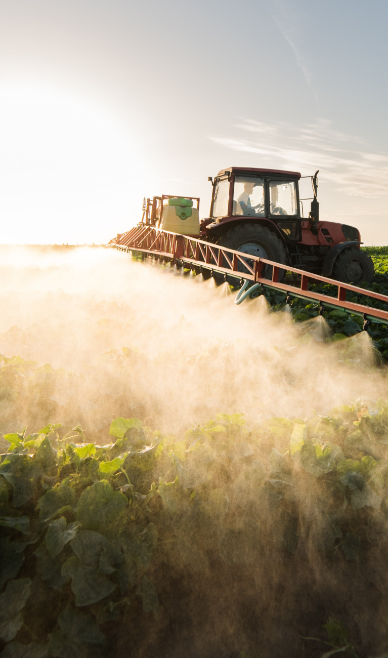 A machine applies fertilizer on a field.