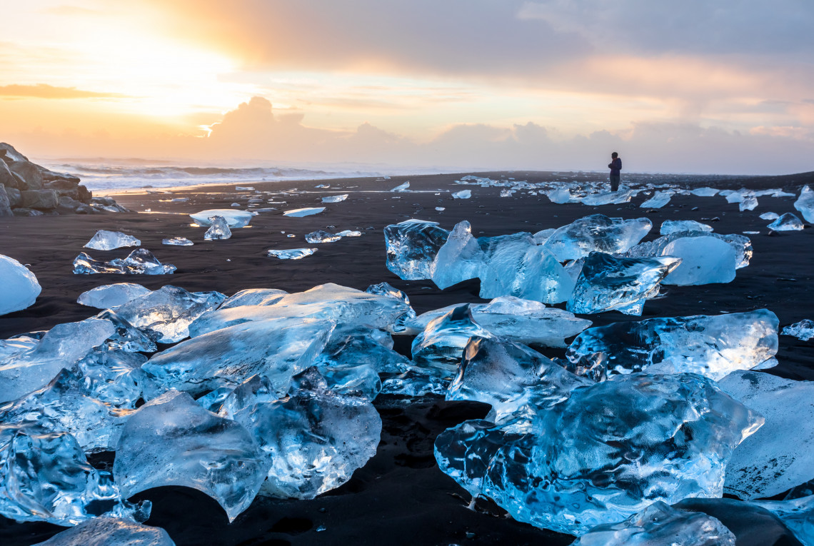 Melting sea ice on the shore with sunset